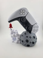 PS5 controller displayed above moon and rocket stand; controller excluded