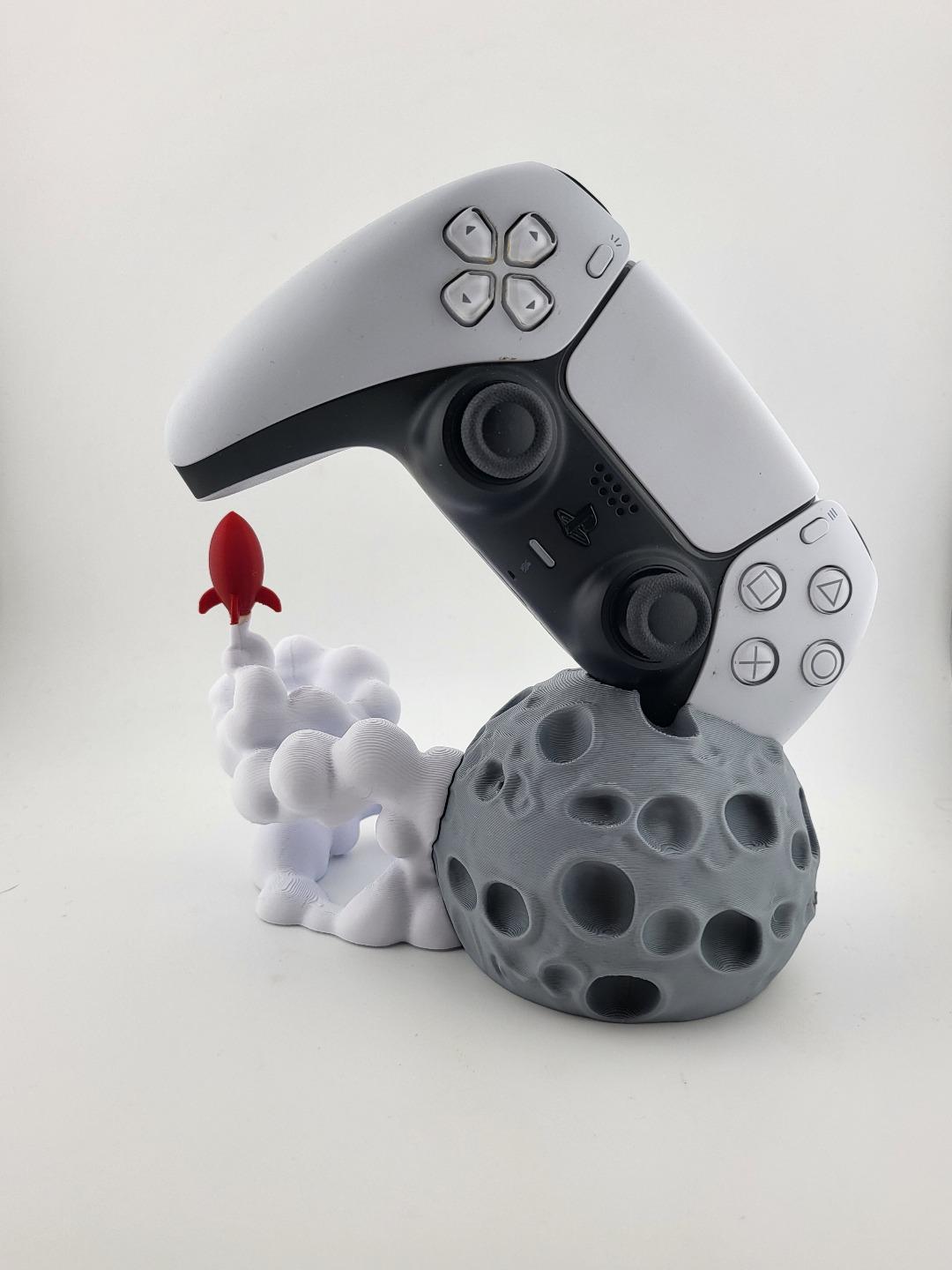 PS5 controller displayed above moon and rocket stand; controller excluded