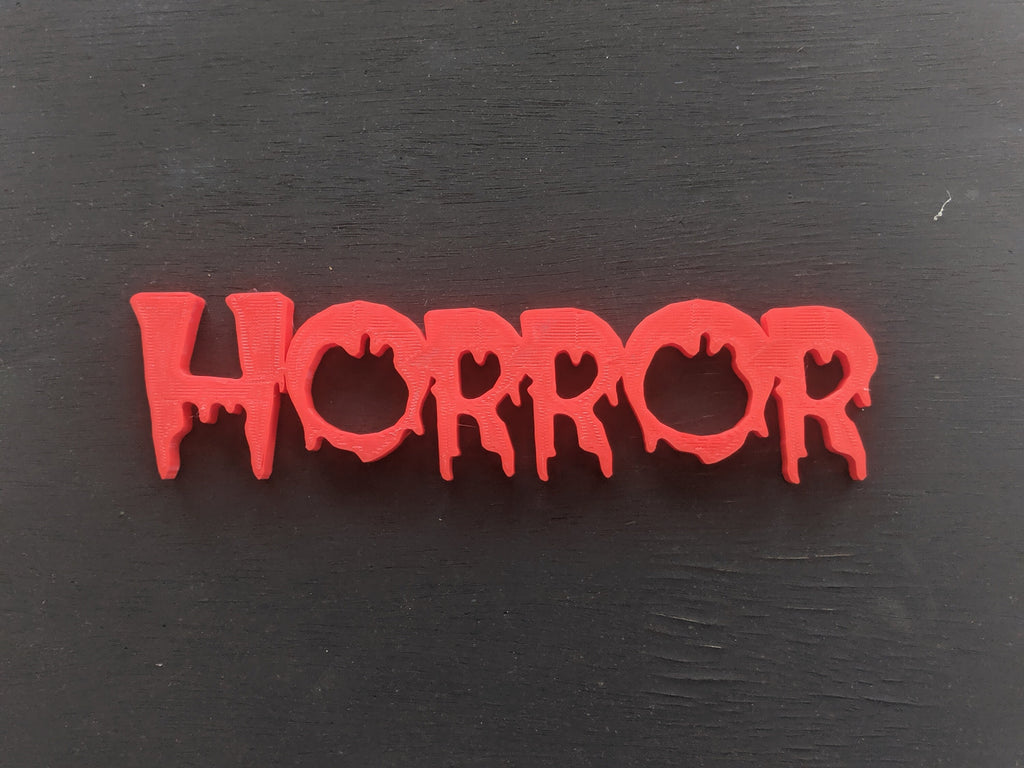 Colorful 3D-printed movie genre sign set on a black background — image 4 of 10