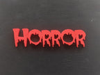 Colorful 3D-printed movie genre sign set on a black background — image 4 of 10