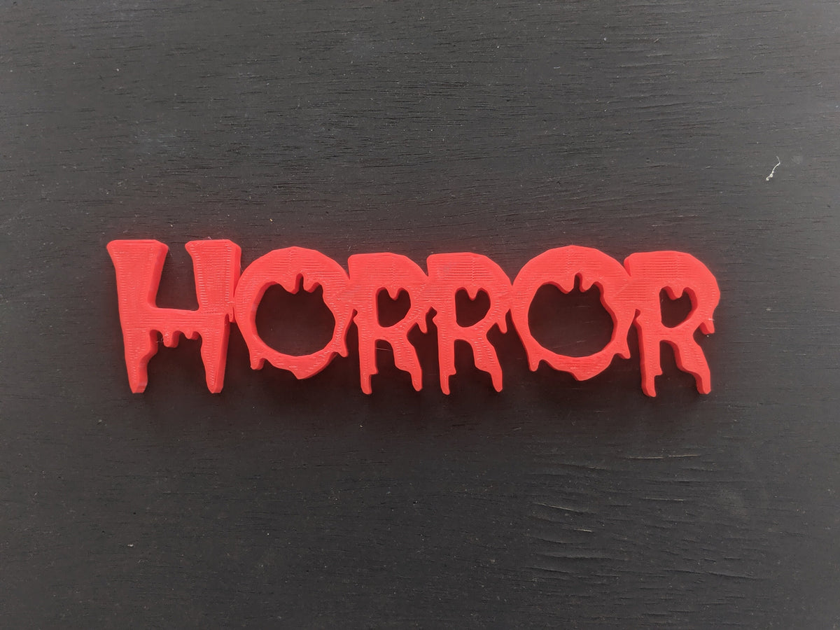Colorful 3D-printed movie genre sign set on a black background — image 4 of 10