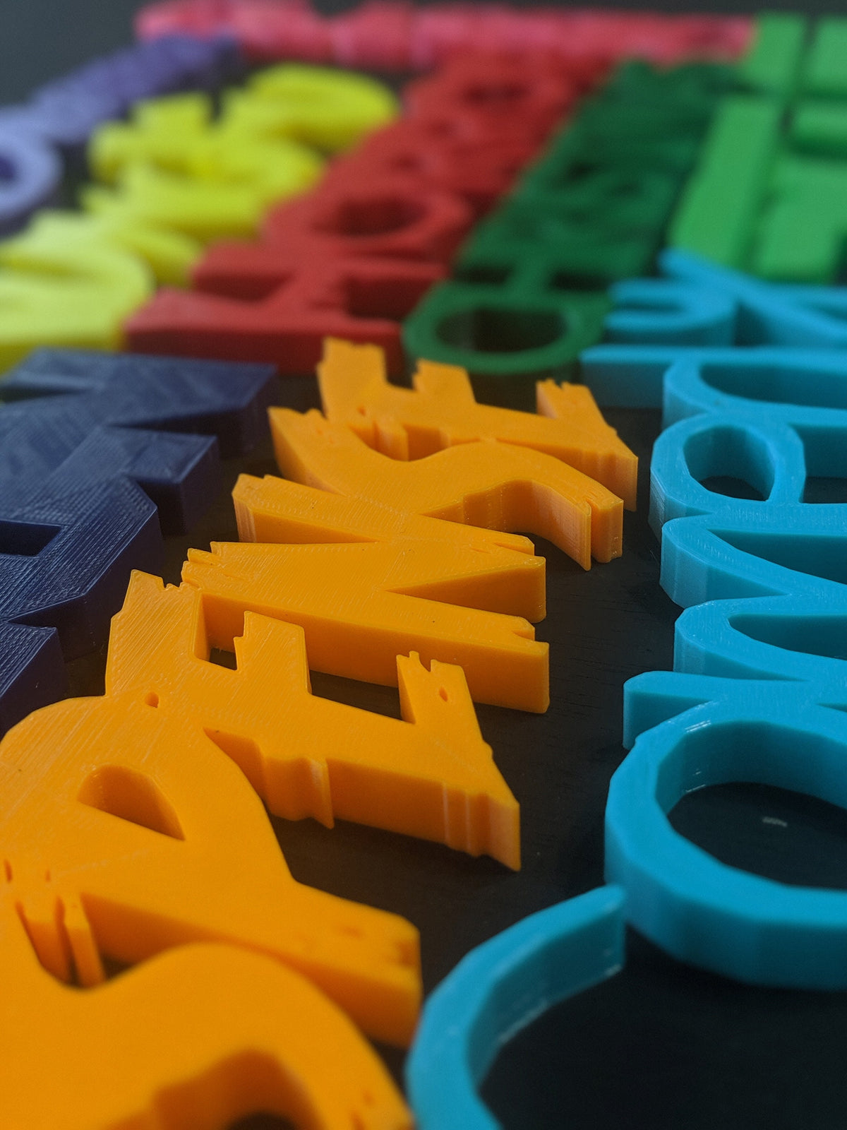 Colorful 3D-printed movie genre sign set on a black background — image 2 of 10