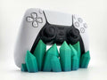 Teal-green crystal-shaped stand holding a PS5 DualSense controller; pictured color example, controller excluded