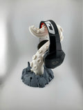 Light tentacle headphone stand with dark gray rocky base holding headphones; headphones excluded