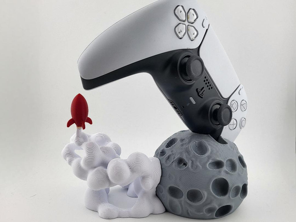 Close view of moon base, launch smoke and red rocket; controller excluded