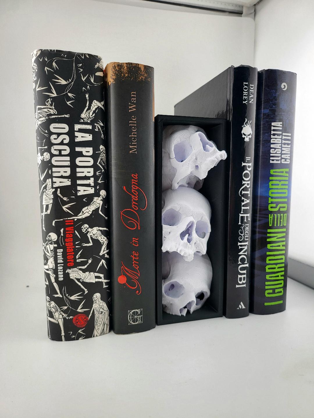 Skull book nook with three pale skulls between books
