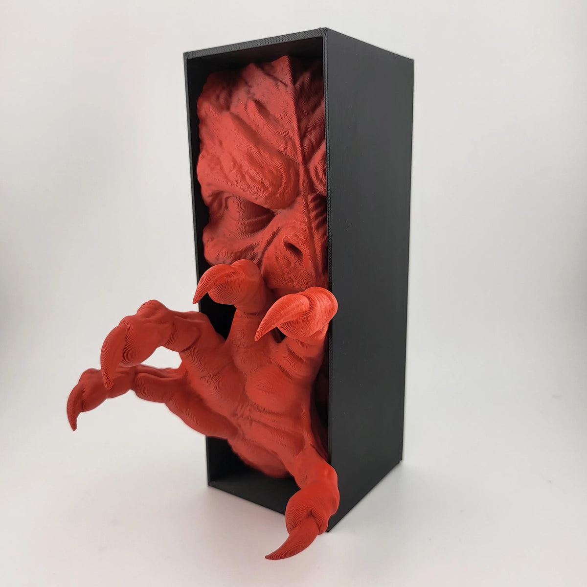 Angled view of the red demon hand book nook and black display box
