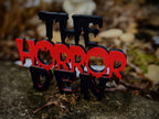 Layered red and black Horror Den 3D-printed sign — image 4 of 5