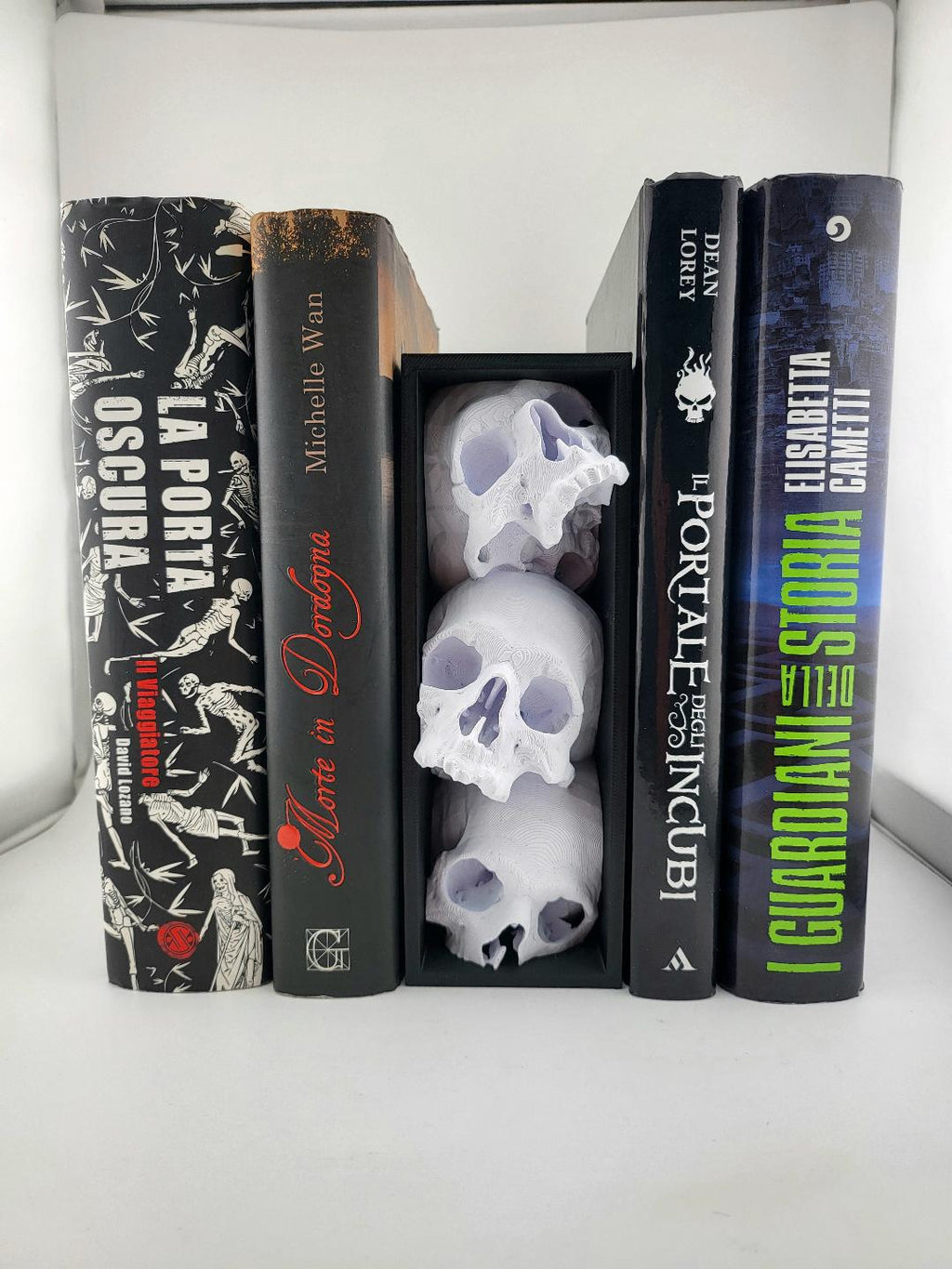 Skull book nook in a black frame displayed between books