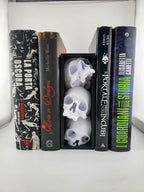 Skull book nook in a black frame displayed between books