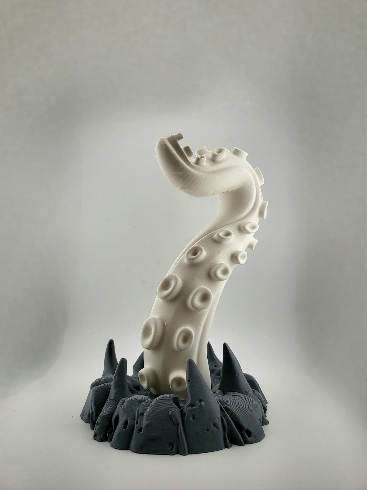 Light curling tentacle and dark gray rocky base without headphones