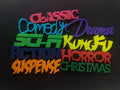 Colorful 3D-printed movie genre sign set on a black background — image 1 of 10