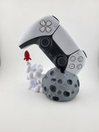 Moon and rocket stand holding a PS5 DualSense controller; controller excluded