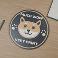 Computer-generated hero render of Much Wow medallion with rounded Shiba-inspired face and paws; charcoal, tan and white.