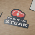 Computer-generated Proof of Steak sign on a wood-grain desk, with a red steak, white diamond emblem and raised letters.