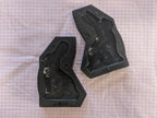 Two open black bunny butter mold halves showing cavities and alignment holes on pink gingham.