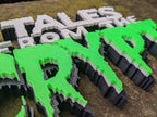 Low-angle close view of the green Crypt lettering, showing pointed drips, textured faces and black sides.